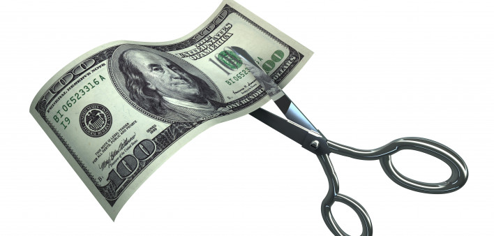 Scissors Cutting One Hundred Dollar Bill