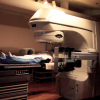 Demonstration of radiation imaging/treatment for prostate cancer, with a subject (not a patient) positioned on treatment table with immobilization device.