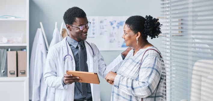 Young African American doctor consulting female patient