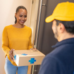 Deliveryman giving medications to customer