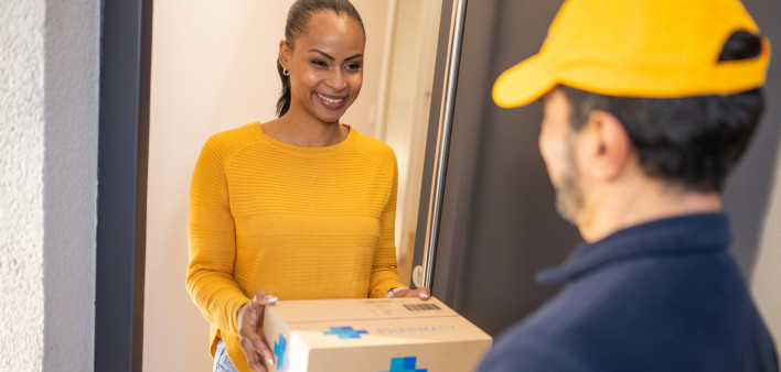 Deliveryman giving medications to customer