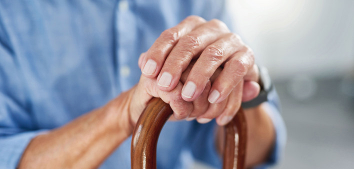old man's hands on a cane