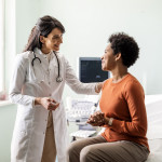 Female medical practitioner reassuring a patient