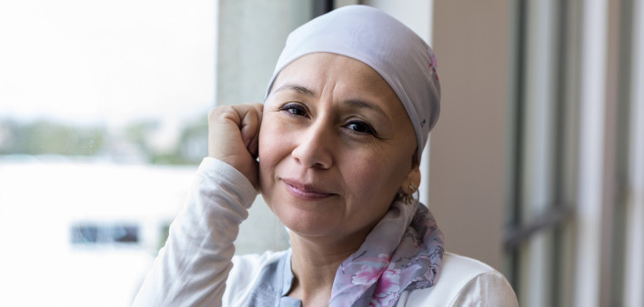A peaceful photo of a breast cancer patient wearing a scarf to cover her head.