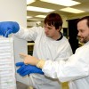 Luis Montaner (right) and a lab assistant at the Wistar Institute retrieve samples from liquid nitrogen frozen storage.
