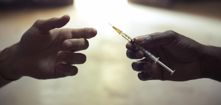 drug users passing a syringe