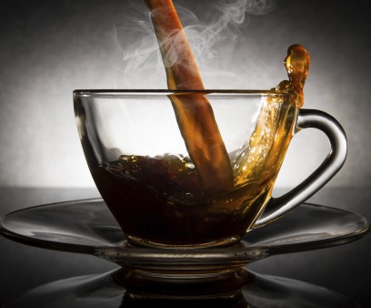 coffee pouring into a clear glass cup