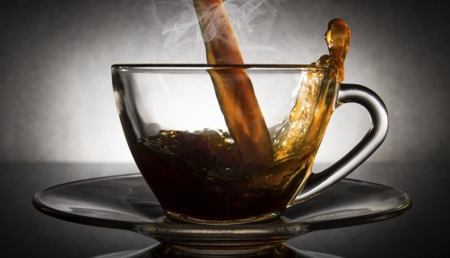 coffee pouring into a clear glass cup
