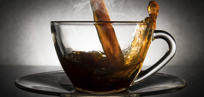 coffee pouring into a clear glass cup