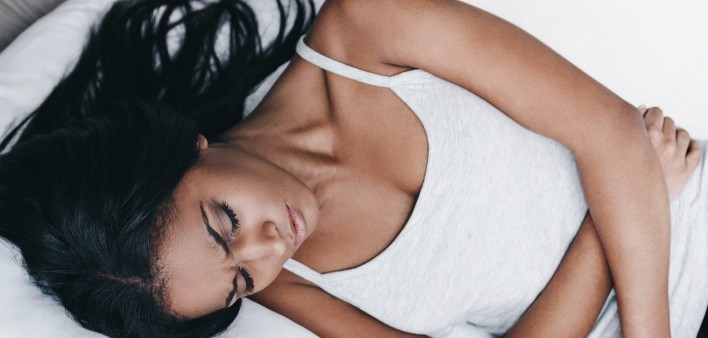 An African American woman sleeping on her side