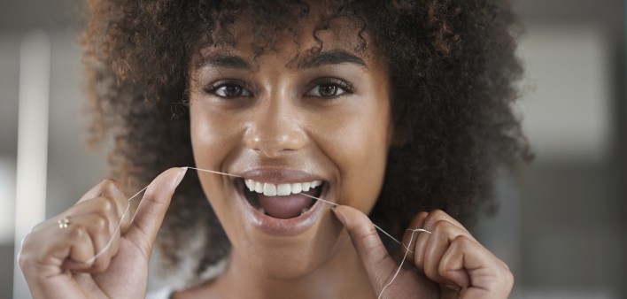 woman flossing teeth