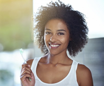 Woman holding toothbrush