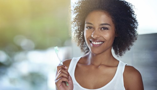Woman holding toothbrush