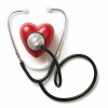 A stethoscope on a red plastic heart