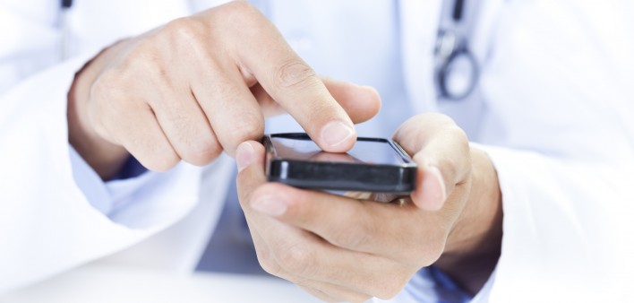  a doctor touching a smart phone