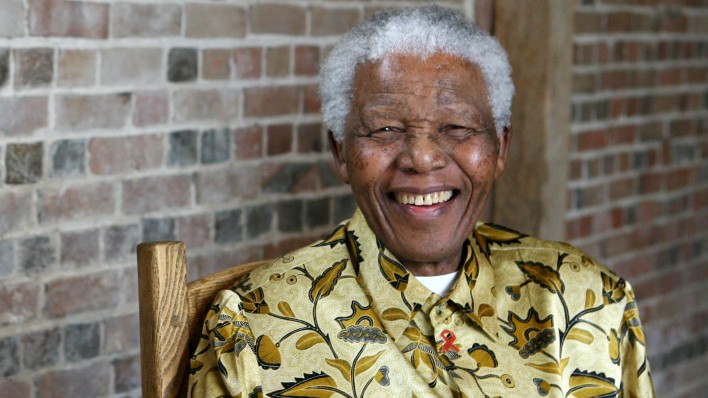 Late South African president Nelson Mandela smiles as he poses for a portrait in London.