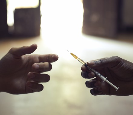 drug users passing a syringe