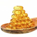Vitamin D Capsules on wooden spoon