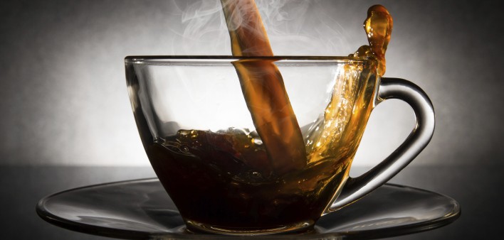 coffee pouring into a clear glass cup