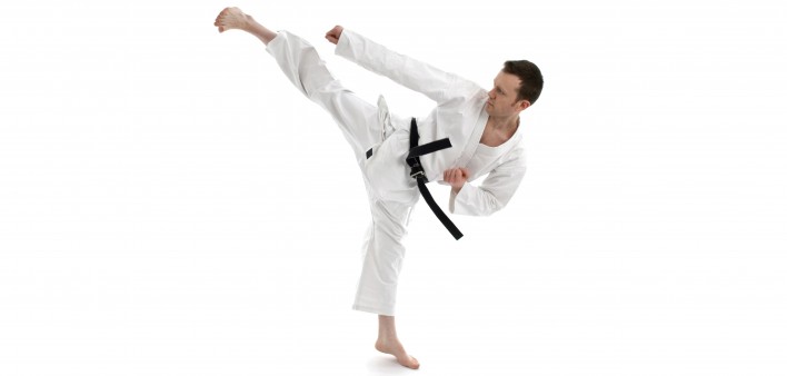 a man in black belt kicking 