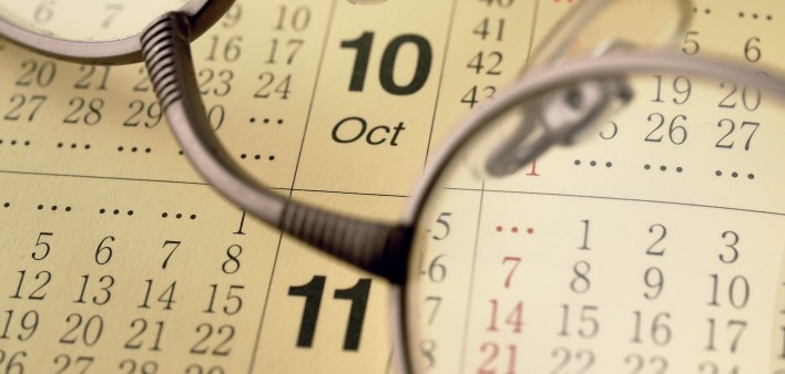 a pair of glassses on top of a calendar
