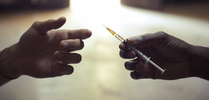 drug users passing a syringe