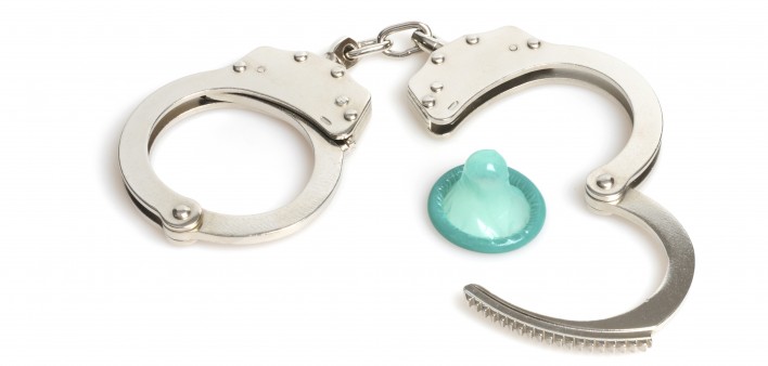 handcuffs and a blue condom