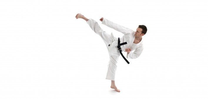 a man in black belt kicking 