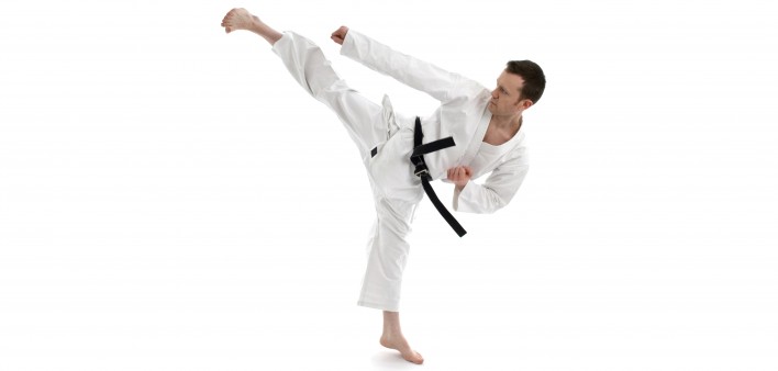 a man in black belt kicking 