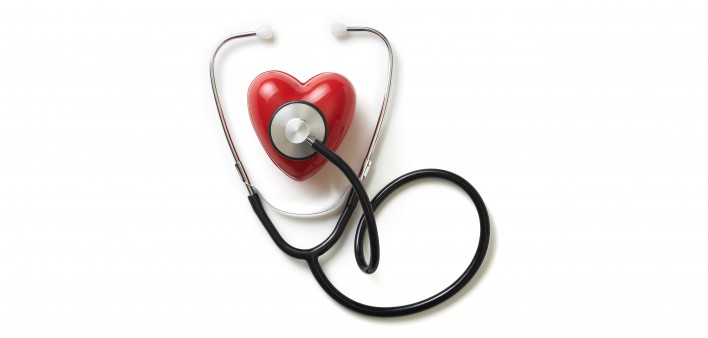 A stethoscope on a red plastic heart