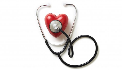 A stethoscope on a red plastic heart