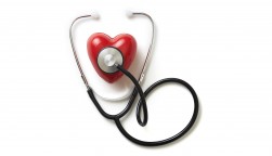 A stethoscope on a red plastic heart