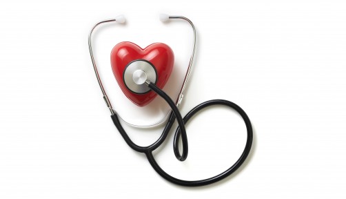 A stethoscope on a red plastic heart