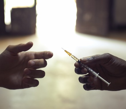 drug users passing a syringe