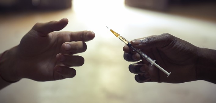 drug users passing a syringe
