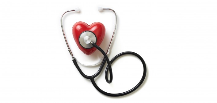 A stethoscope on a red plastic heart