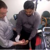 A technician tests a patient's abductor pollicis brevis muscle to help make a diagnosis for carpal tunnel syndrome.