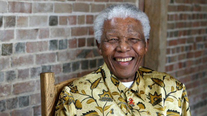 Late South African president Nelson Mandela smiles as he poses for a portrait in London.