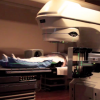 Demonstration of radiation imaging/treatment for prostate cancer, with a subject (not a patient) positioned on treatment table with immobilization device.