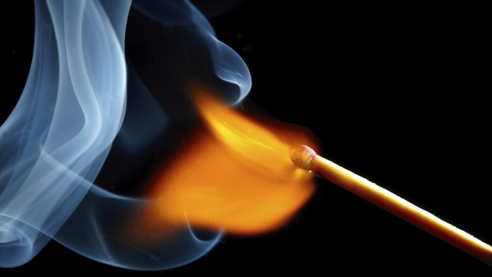 igniting match and smoke