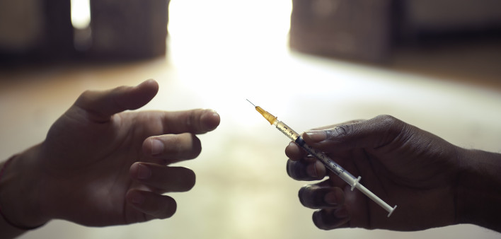 drug users passing a syringe