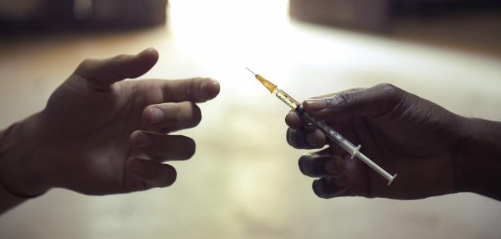 drug users passing a syringe