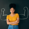 strong woman crossed arms blackboard