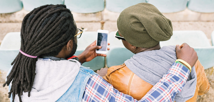 two men arm in arm taking selfie