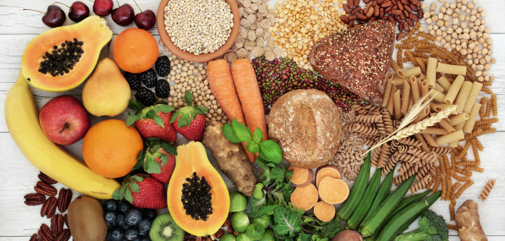 food with high fiber content for a healthy diet with fruit, vegetables, whole wheat bread, pasta, nuts, legumes, grains and cereals