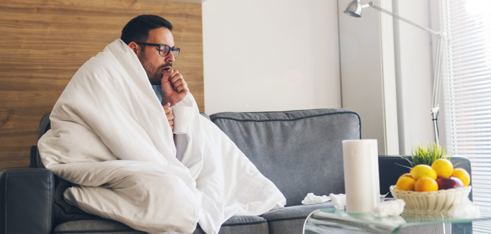 Young man suffering from cold and coughing
