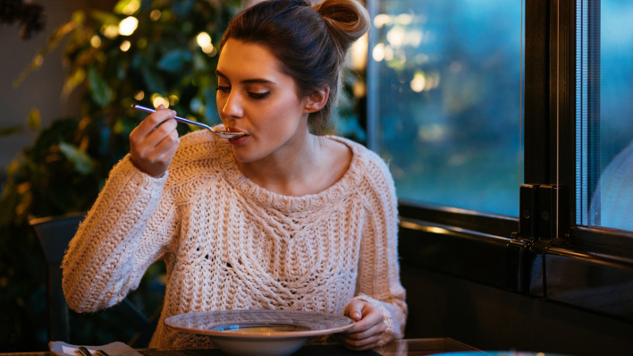 Beautiful girl having dinner at cafe - Stock image Restaurant, Ukraine, Soup, Eating, Women