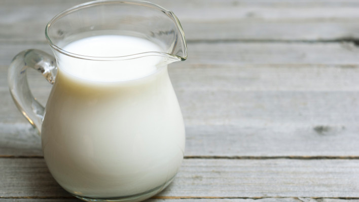 pitcher of milk on wooden table