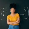 strong woman crossed arms blackboard