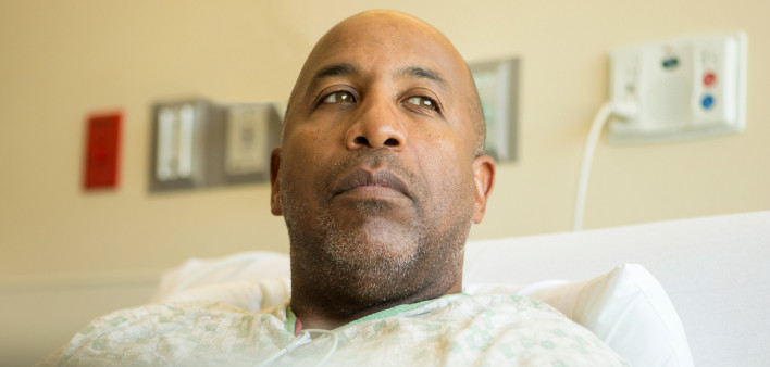 man in bed in hospital contemplative